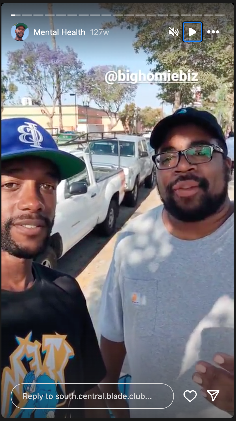 To men look at the camera with a shaded park in the background.